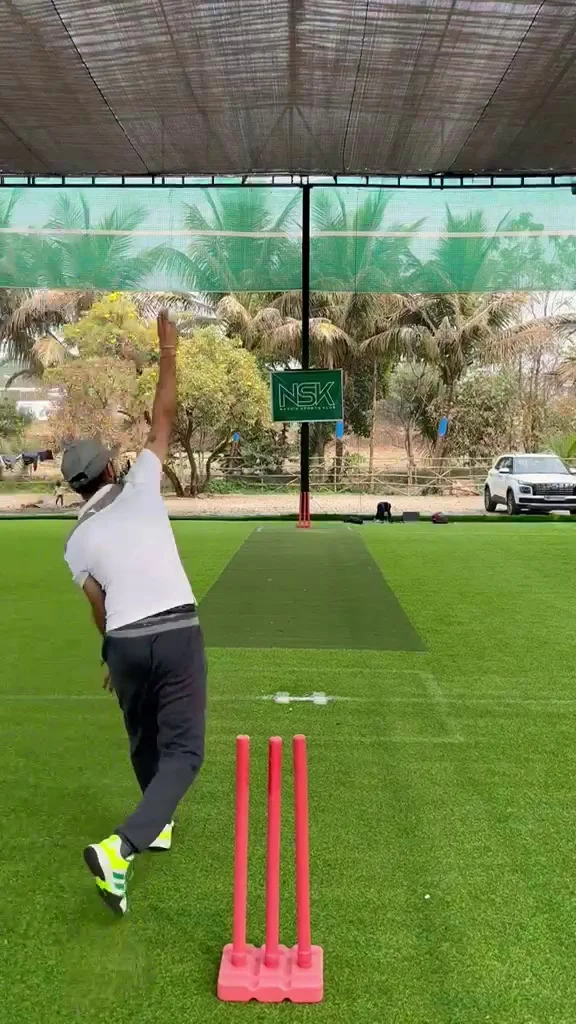 AthlezTech founder Jyotprakash Singh Chhabra bowling at a turf net, filmed from behind the stumps.